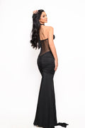 Back view of the Aura Black Mesh Maxi Dress with sheer mesh back and elegant ruched silhouette.
