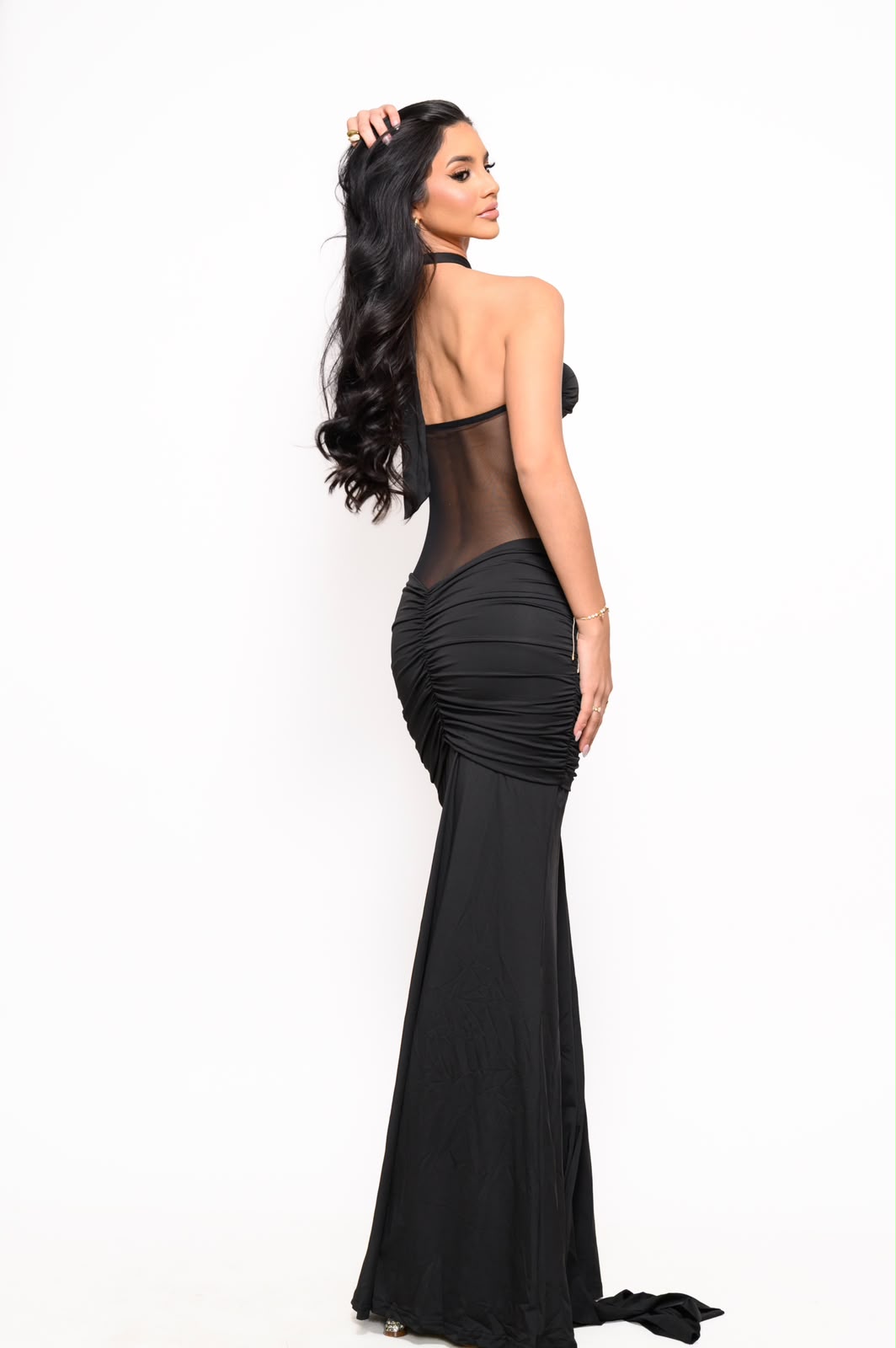 Back view of the Aura Black Mesh Maxi Dress with sheer mesh back and elegant ruched silhouette.